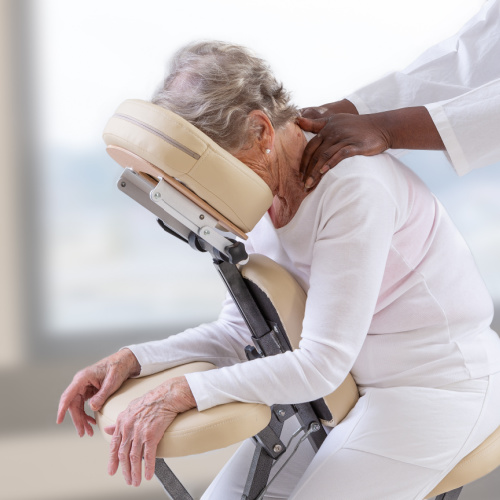 An older lady getting a chair massage